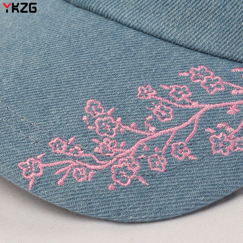 Pink botanical embroidery on denim fabric