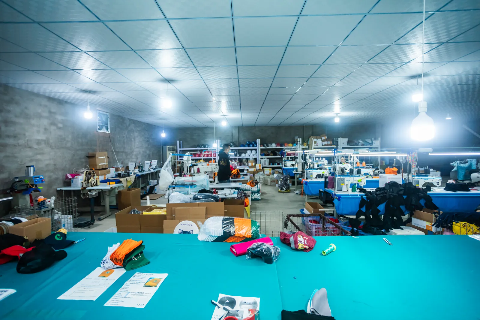 Jiesa cap production workshop with cutting table and sewing stations